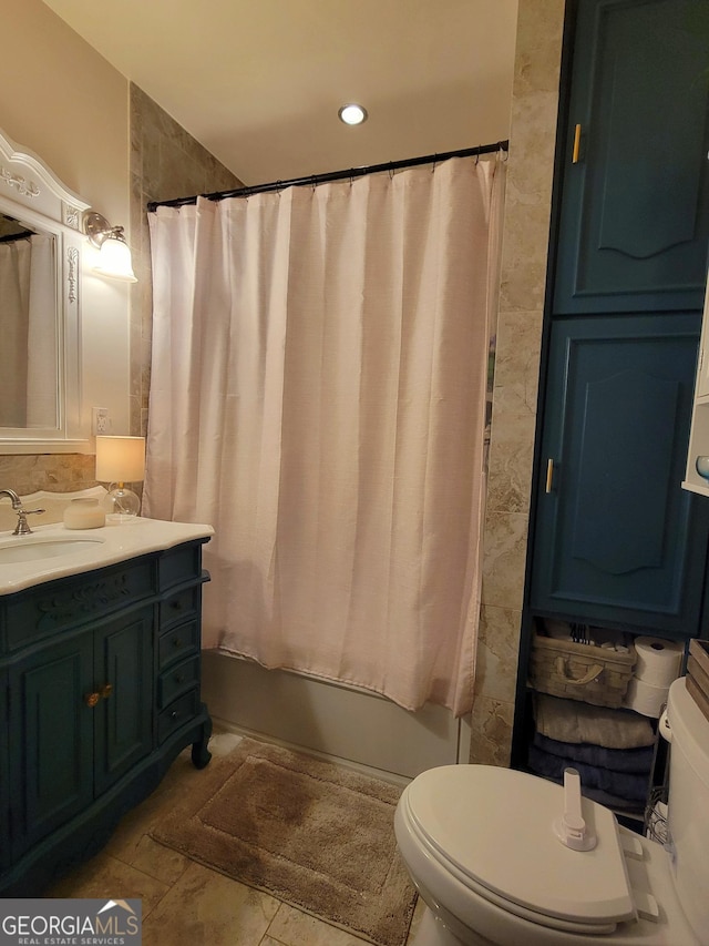 full bathroom with vanity, shower / bath combination with curtain, and toilet