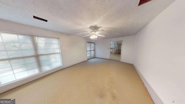 spare room featuring ceiling fan and a textured ceiling