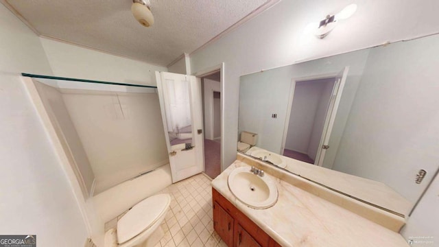 bathroom with vanity, toilet, and a textured ceiling