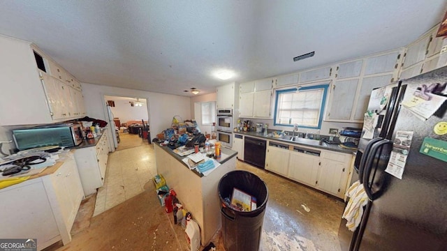 kitchen featuring sink, a textured ceiling, and black appliances