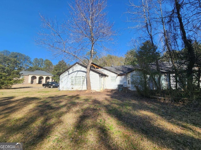 view of property exterior with a lawn