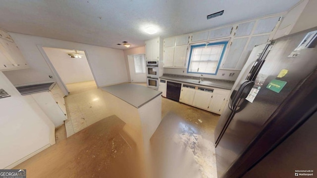 kitchen featuring stainless steel appliances and white cabinets