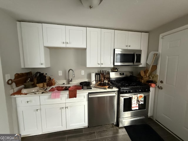 kitchen featuring stainless steel appliances, sink, and white cabinets