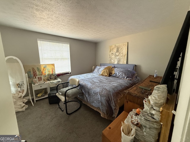 bedroom with dark colored carpet and a textured ceiling