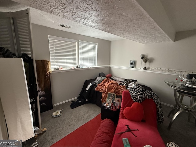 bedroom with carpet and a textured ceiling