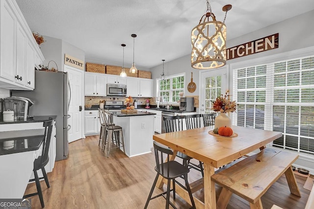 dining room with sink and light hardwood / wood-style floors