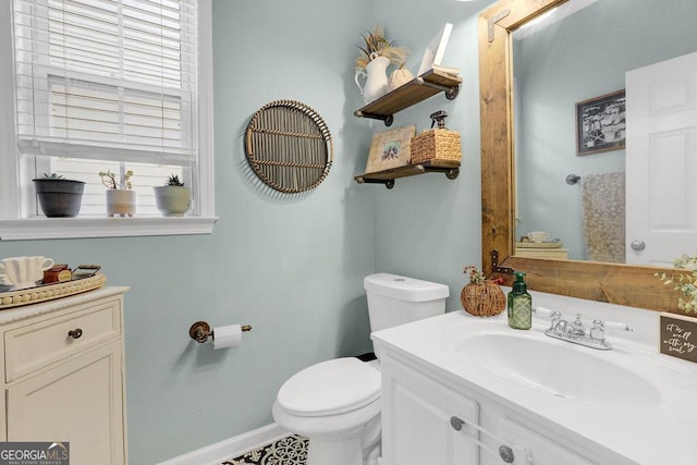 bathroom featuring vanity and toilet