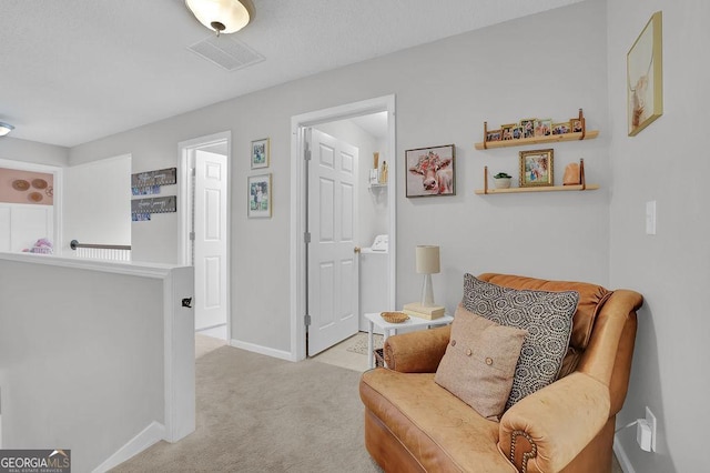 sitting room featuring light colored carpet