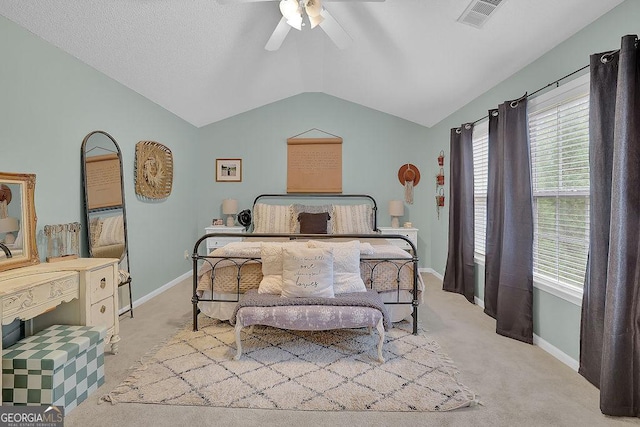 bedroom featuring ceiling fan, lofted ceiling, and light carpet