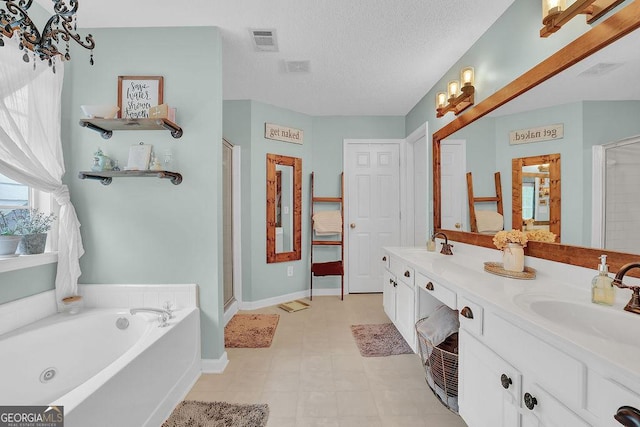 bathroom featuring vanity, shower with separate bathtub, and a textured ceiling