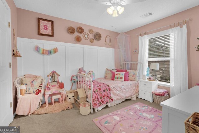 bedroom featuring ceiling fan and carpet