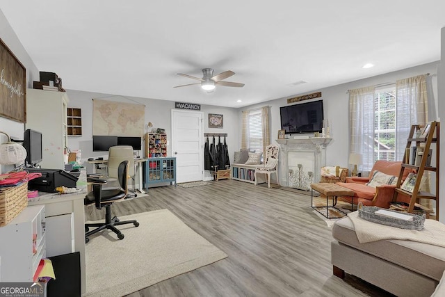 office with ceiling fan and light hardwood / wood-style floors