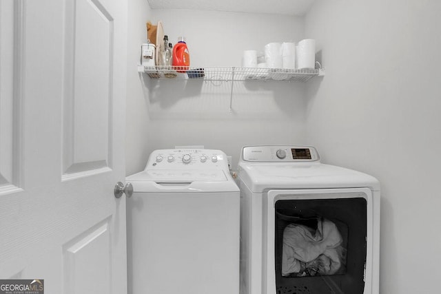 laundry room with independent washer and dryer