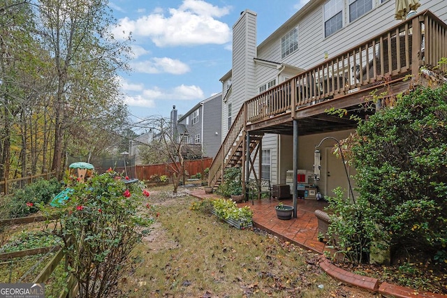 view of yard featuring a wooden deck and a patio area