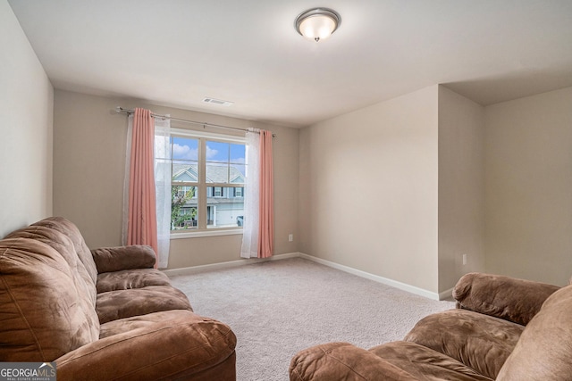 sitting room featuring light carpet