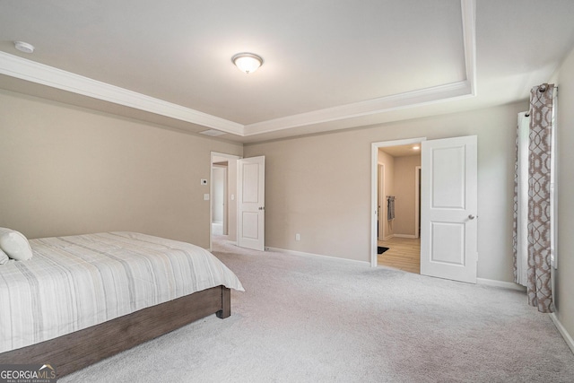 carpeted bedroom featuring crown molding and a tray ceiling