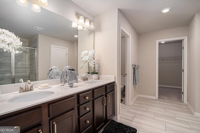 bathroom featuring walk in shower, vanity, and toilet