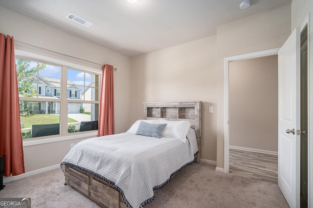 bedroom with light colored carpet