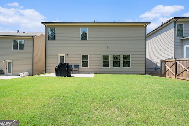 rear view of house with a yard and a patio