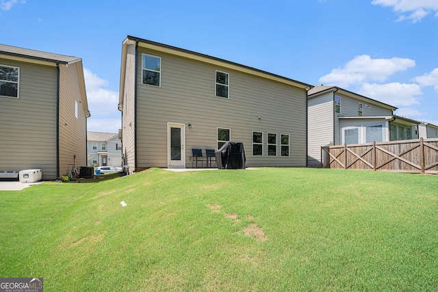 back of house with a lawn and central air condition unit