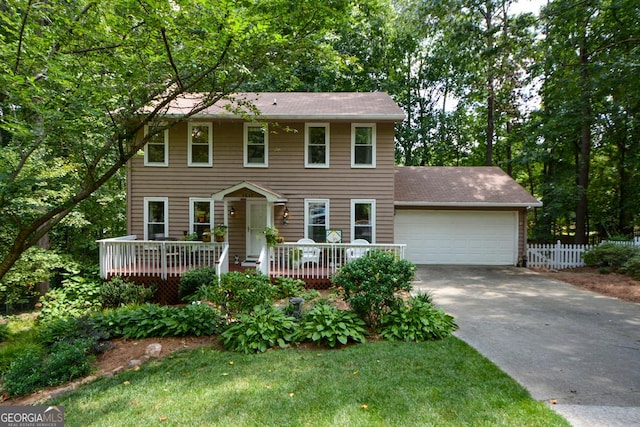 colonial inspired home with a garage and a wooden deck