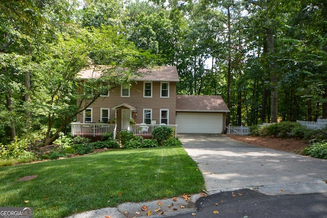 colonial-style house with a garage, a wooden deck, and a front lawn