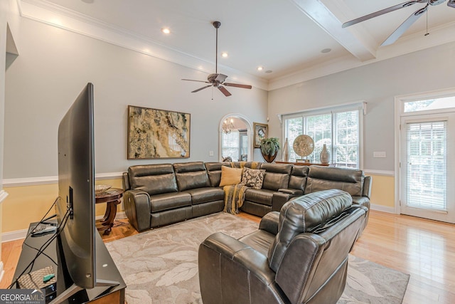 living room featuring crown molding, ceiling fan, beam ceiling, and light hardwood / wood-style flooring