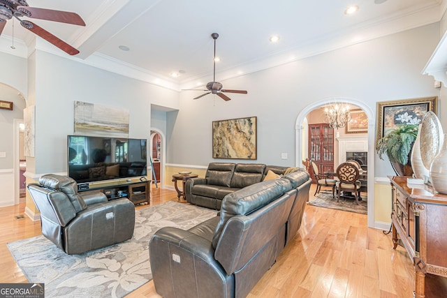 living room with crown molding, ceiling fan, and light hardwood / wood-style flooring