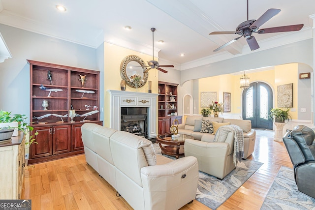 living room with french doors, ceiling fan, ornamental molding, and light hardwood / wood-style floors