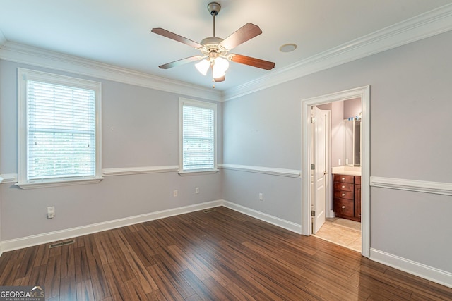 unfurnished bedroom with connected bathroom, hardwood / wood-style floors, ornamental molding, and ceiling fan