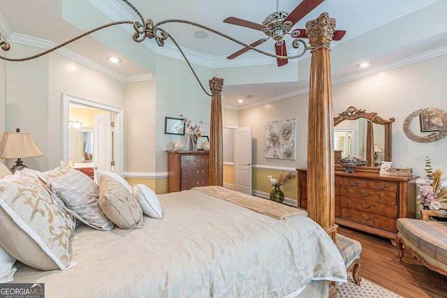 bedroom featuring ceiling fan, ornamental molding, wood-type flooring, and ensuite bathroom