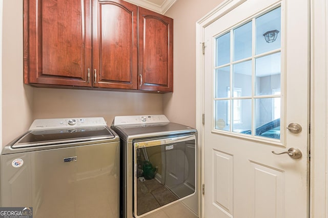 laundry room featuring cabinets and washing machine and clothes dryer