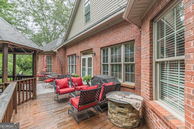 deck featuring a gazebo and outdoor lounge area