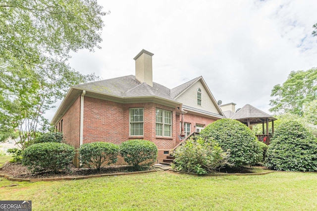 view of side of property with a lawn