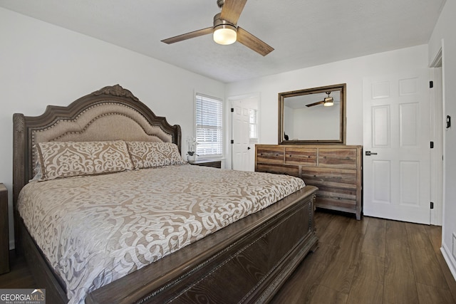 bedroom with ceiling fan and dark hardwood / wood-style flooring