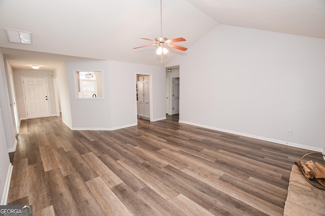 interior space featuring dark wood-type flooring, ceiling fan, and vaulted ceiling