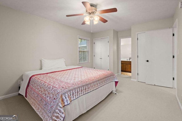 bedroom with ensuite bath, ceiling fan, and carpet