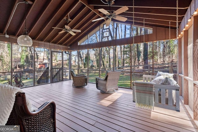 sunroom featuring vaulted ceiling with beams and ceiling fan