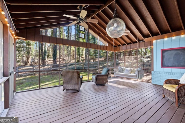 unfurnished sunroom with vaulted ceiling and ceiling fan