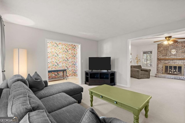 living room with ceiling fan, carpet floors, and a brick fireplace