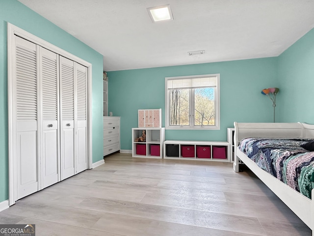 bedroom featuring a closet and light hardwood / wood-style flooring