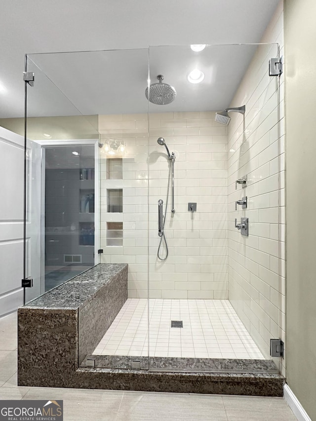 bathroom featuring a shower with door