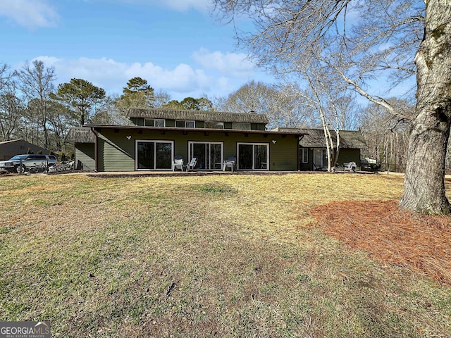 back of property featuring a lawn