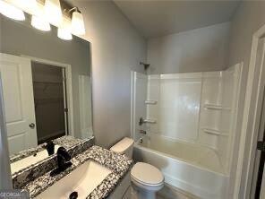 full bathroom with vanity, bathtub / shower combination, and toilet