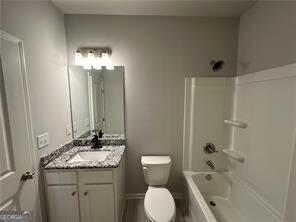 full bathroom with shower / tub combination, vanity, and toilet