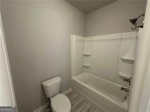 bathroom with toilet and shower / bath combination