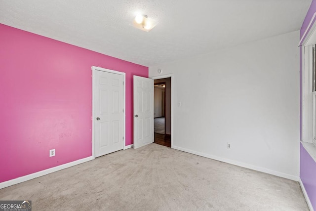 unfurnished bedroom with light carpet