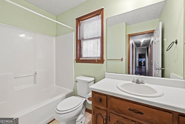 full bathroom featuring vanity, bathtub / shower combination, and toilet