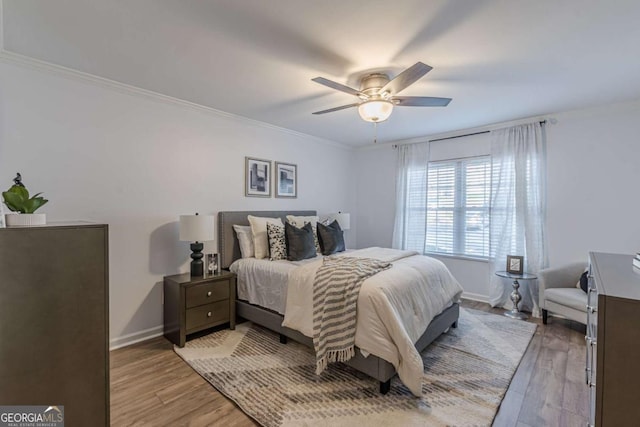 bedroom featuring crown molding, ceiling fan, and light hardwood / wood-style floors