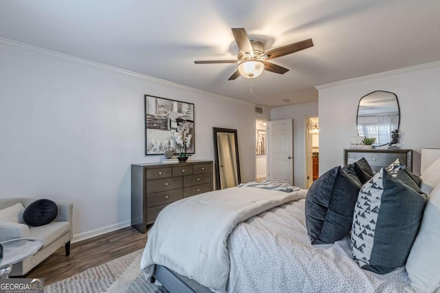 bedroom featuring hardwood / wood-style flooring, crown molding, and ceiling fan